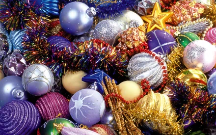 A vibrant collection of colorful Christmas ornaments and tinsel, creating a festive holiday backdrop for your PC desktop wallpaper.
