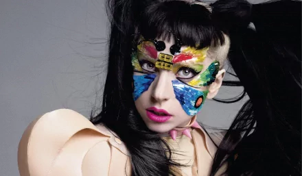 HD PC desktop wallpaper featuring Lady Gaga with vibrant butterfly face paint, blending music and bold artistic expression.