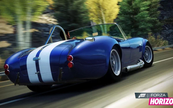 HD PC desktop wallpaper featuring a classic blue Shelby Cobra with white racing stripes from the video game Forza Horizon, speeding along a scenic road.