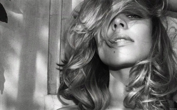 Black and white HD desktop wallpaper featuring a close-up portrait of celebrity Rachel McAdams with tousled hair partially covering her face.