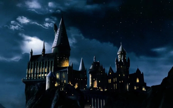 HD wallpaper of Hogwarts Castle at night from Harry Potter and the Philosopher's Stone with a lightning-streaked sky.