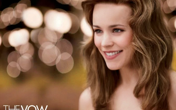 HD desktop wallpaper featuring Rachel McAdams smiling warmly with soft bokeh lights in the background, from the movie The Vow.