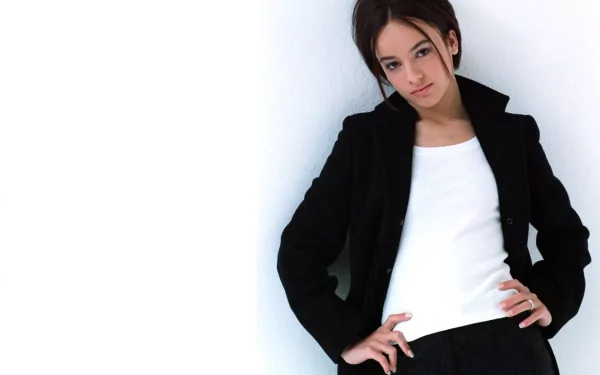 HD PC desktop wallpaper featuring Alizée posing confidently against a white background, representing music and style.