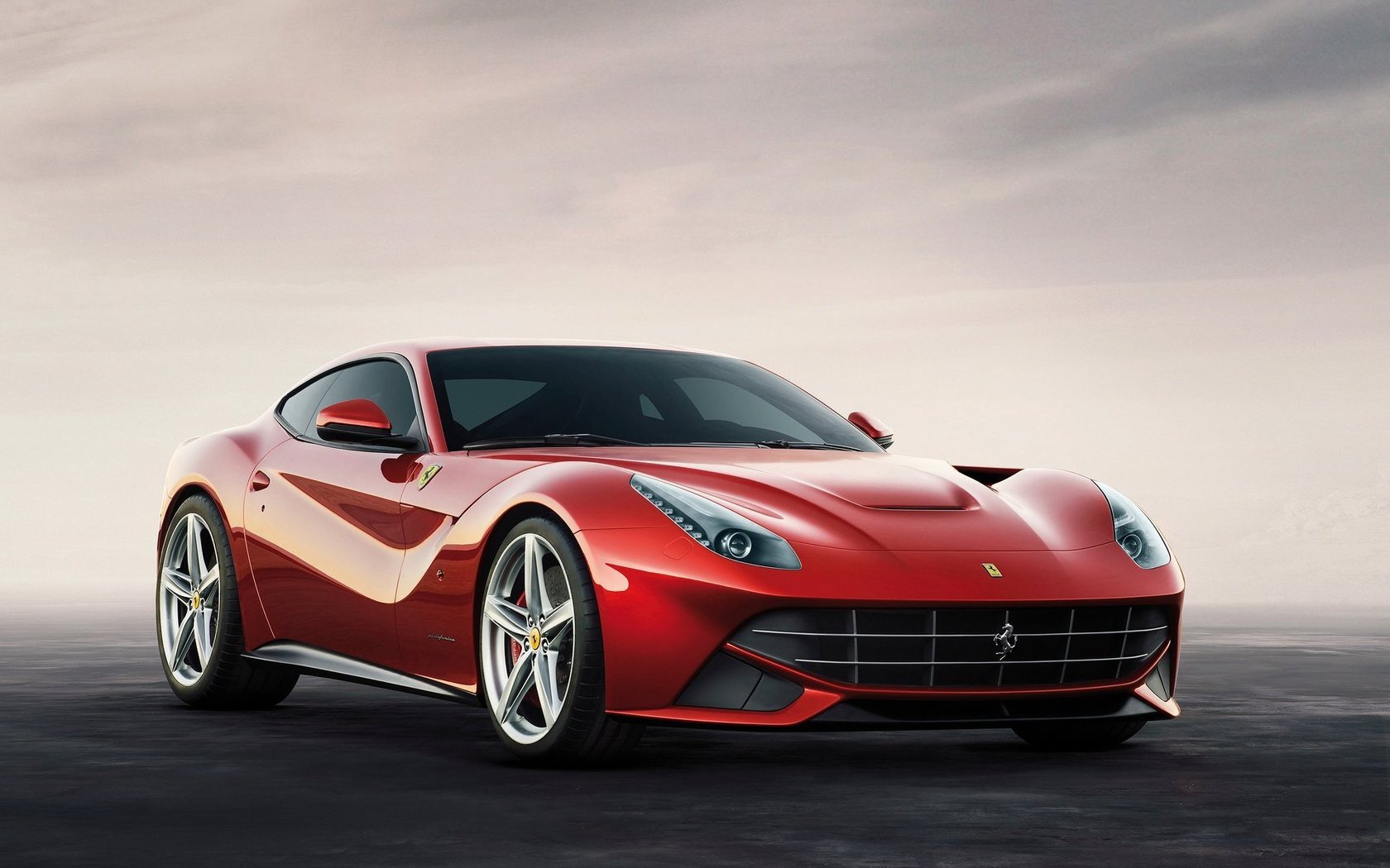 HD desktop wallpaper of a Ferrari F12berlinetta with a sleek red design against a blur background.