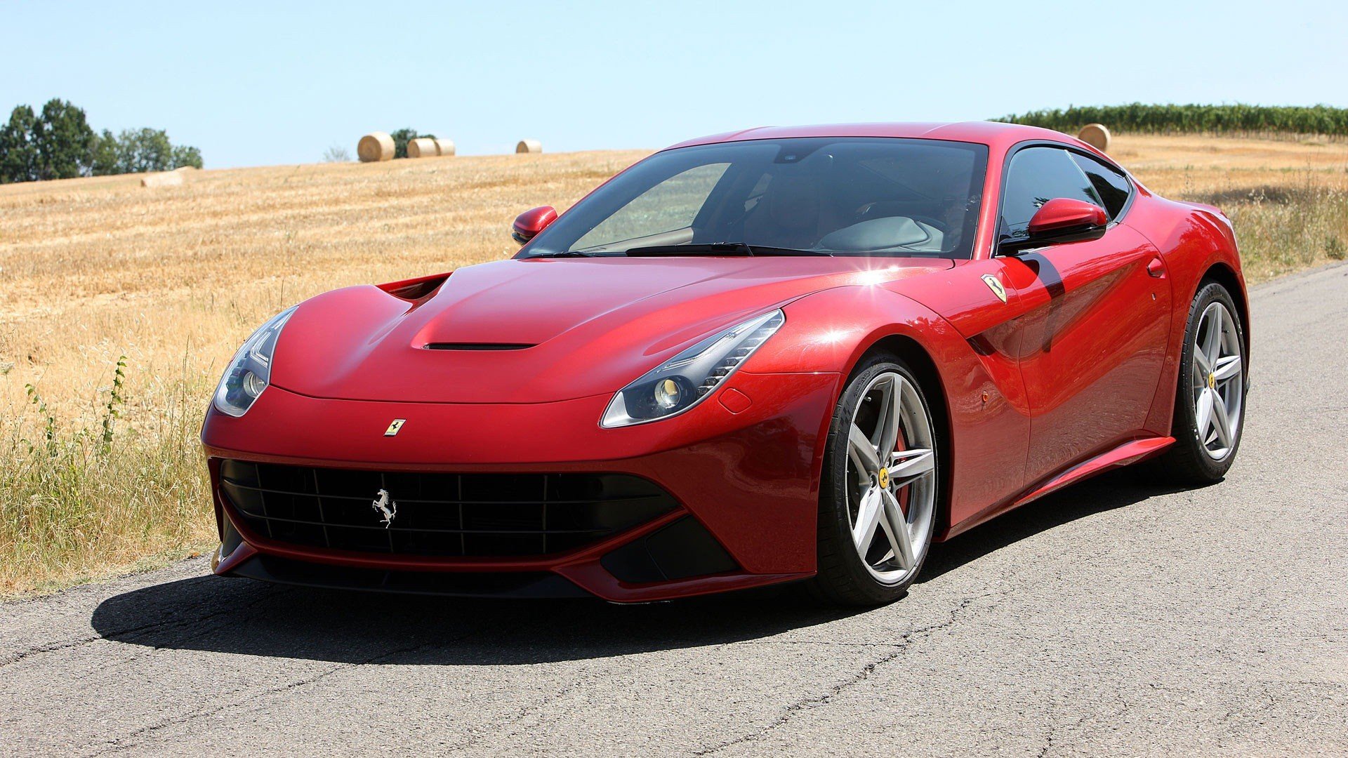 Red Ferrari F12berlinetta parked outdoors, HD desktop wallpaper and background.