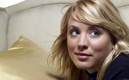 Close-up of a smiling Kaley Cuoco, featuring her blonde hair and expressive eyes, set against a soft background. This image serves as a high-definition PC desktop wallpaper.