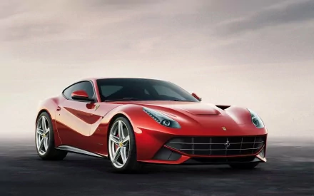 HD desktop wallpaper of a Ferrari F12berlinetta with a sleek red design against a blur background.