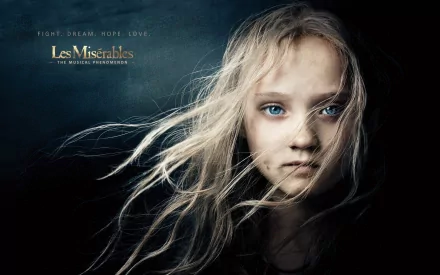 HD PC desktop wallpaper featuring Isabelle Allen from the 2012 movie Les Misérables, with a close-up of her face and flowing hair against a dark background.
