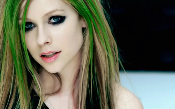 HD desktop wallpaper of Avril Lavigne with long hair featuring green highlights, dark eye makeup, and a soft expression. Tagged with music.