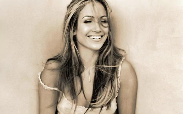 Sepia-toned HD PC desktop wallpaper of a smiling woman with long hair in a sleeveless top, relaxed pose against a soft, textured neutral background.