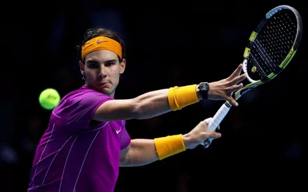 HD PC desktop wallpaper featuring Rafael Nadal in action during a tennis match, highlighting his focused expression and dynamic sports pose.