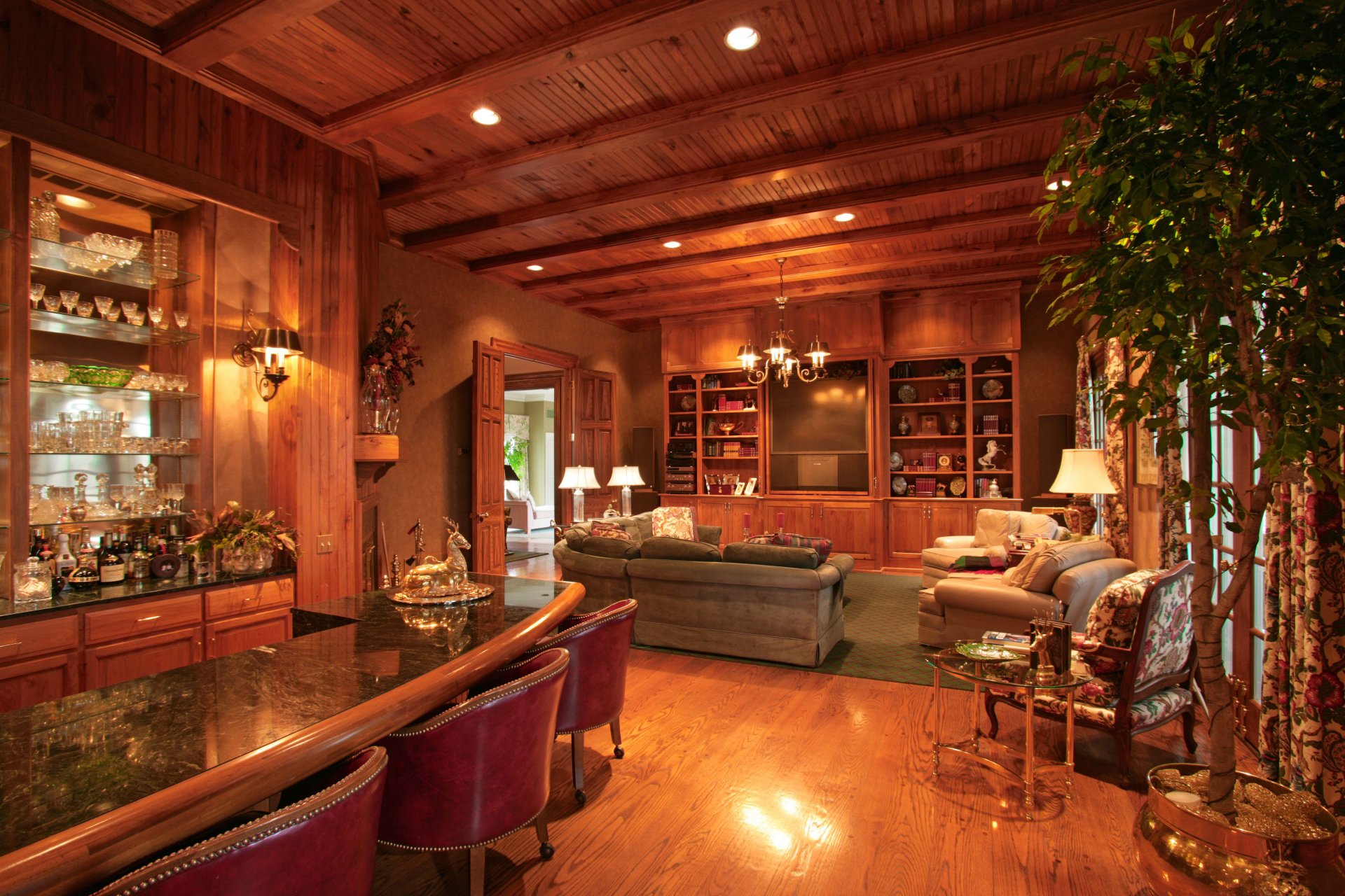 A cozy room with wooden beams and elegant furnishings, featuring a bar, plush seating, and a stylish decor, captured as a 4K Ultra HD PC desktop wallpaper.