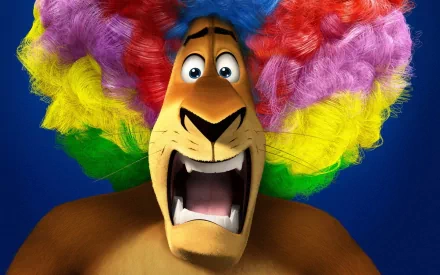 A vibrant HD wallpaper featuring a spirited character from Madagascar 3: Europe's Most Wanted, showcasing a lion with a colorful clown wig and an expressive, surprised expression.