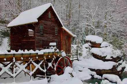 Snow-covered Glade Creek Grist Mill, a historic watermill in West Virginia's Babcock State Park, captured in a crisp 4K Ultra HD desktop wallpaper.
