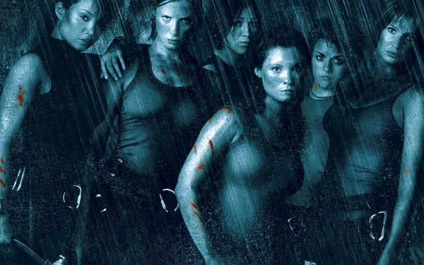 HD desktop wallpaper featuring the intense female cast of the movie The Descent, set against a dark, rainy background conveying suspense and tension.