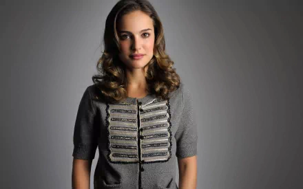 HD desktop wallpaper featuring celebrity Natalie Portman against a plain gray background, dressed in a stylish gray top with intricate detailing.