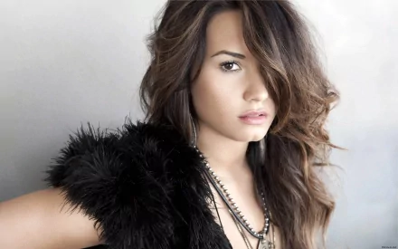 Demi Lovato poses confidently in a stylish outfit, captured in this HD PC desktop wallpaper, embodying her powerful presence in the music scene.