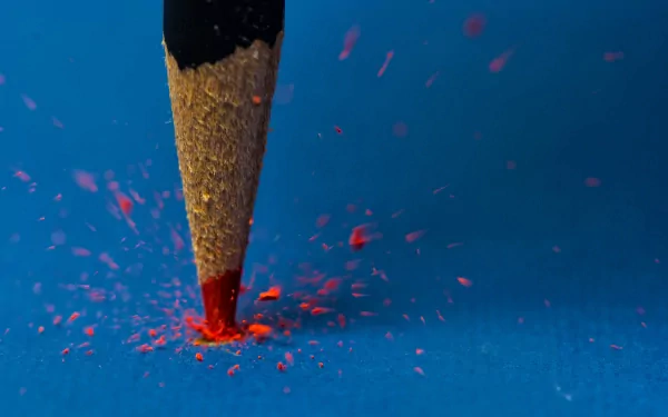 Close-up photography of a sharpened pencil tip drawing with red lead, captured in HD quality, serving as a striking PC desktop wallpaper and background.