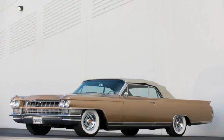 HD PC desktop wallpaper/background of a classic vehicle — a tan 1964 Cadillac Eldorado convertible parked against a white wall.