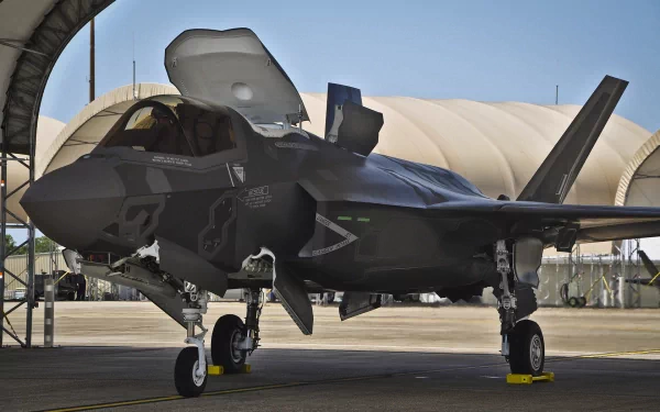 Lockheed Martin F-35 Lightning II military jet parked on runway, shown in high-definition detail, designed as a PC desktop wallpaper and background image.