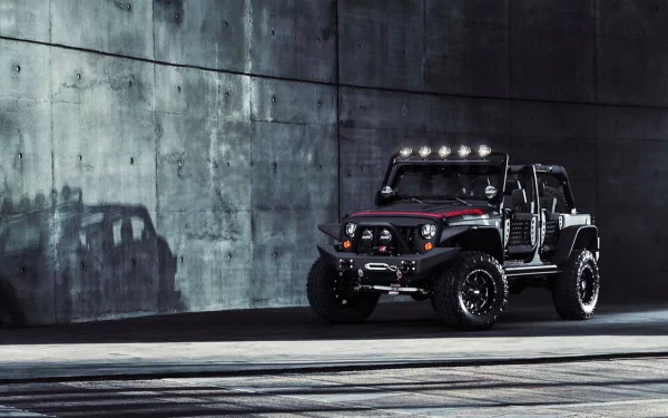 HD wallpaper featuring a rugged Jeep next to a concrete wall, casting a distinct shadow. The dark-toned background contrasts with the vehicle, creating a striking visual for desktop screens.