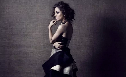 HD PC desktop wallpaper featuring celebrity Eliza Dushku in a stylish black and white dress against a textured gray background.