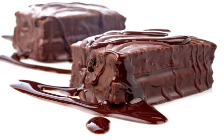 HD desktop wallpaper featuring two chocolate cakes drizzled with rich chocolate sauce on a white background, emphasizing texture and indulgence.