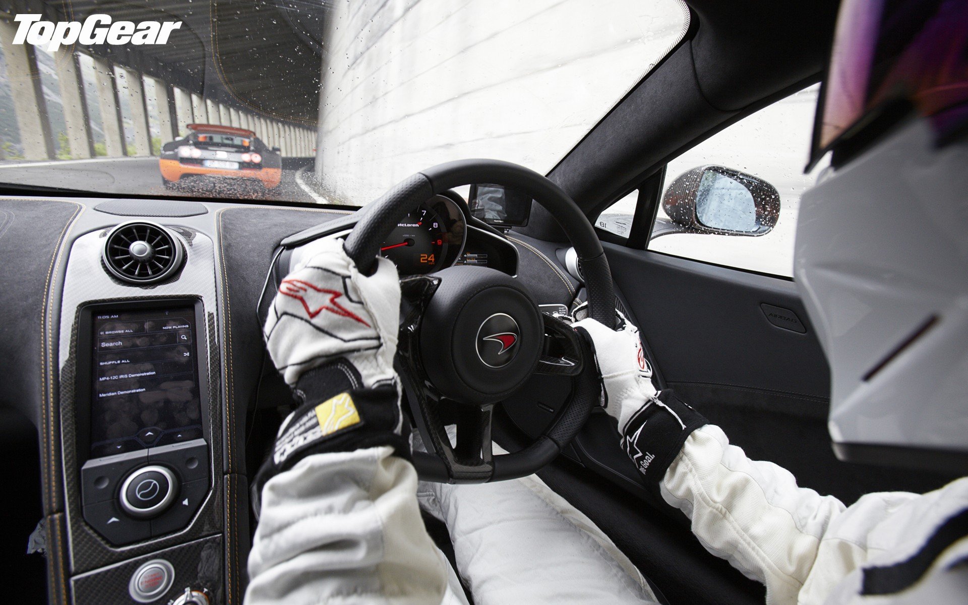 HD Top Gear desktop wallpaper showing a driver's view from inside a car, with another car in pursuit, and the Top Gear logo displayed.