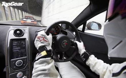 HD Top Gear desktop wallpaper showing a driver's view from inside a car, with another car in pursuit, and the Top Gear logo displayed.