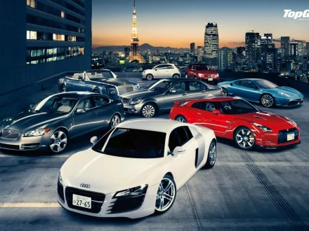 HD Top Gear wallpaper featuring a lineup of high-end cars with a city skyline in the background.