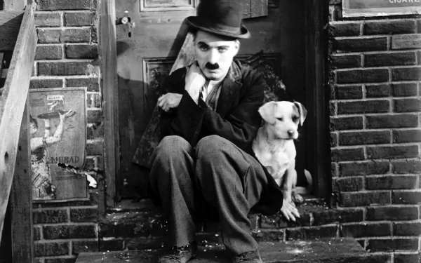 Charlie Chaplin sits on steps next to a dog in a scene from the movie A Dog's Life. This HD desktop wallpaper captures a poignant moment against a backdrop of a brick building.