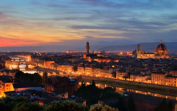 A stunning HD desktop wallpaper capturing the evening skyline of Florence, Italy, featuring the illuminated Florence Cathedral and historic cityscape.