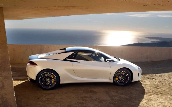 Sleek white Lotus sports car parked by a coastal view, captured in an HD PC desktop wallpaper and background.