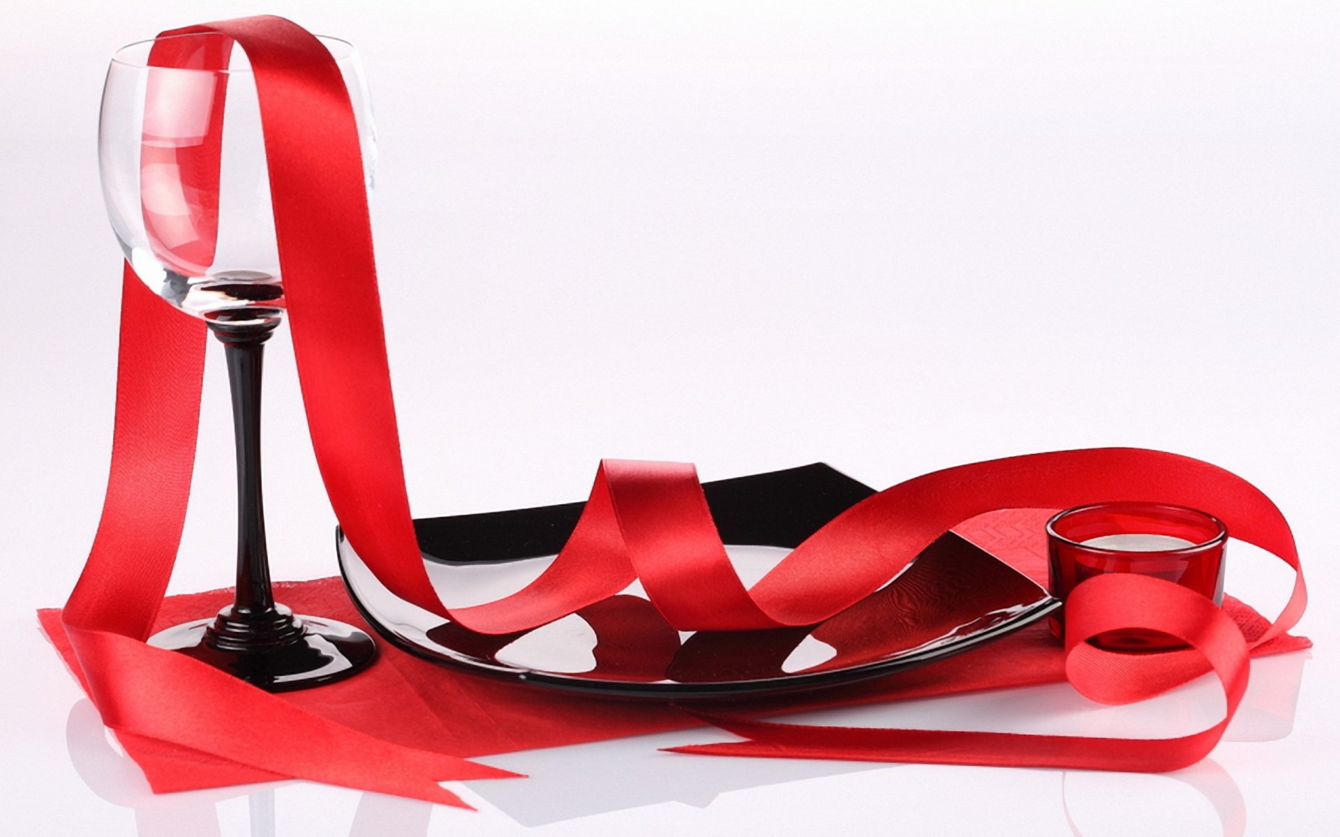 HD PC desktop wallpaper featuring a red ribbon draped over a wine glass and plate, evoking a festive Valentine’s Day holiday atmosphere.