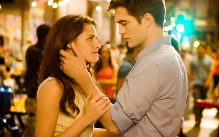 A romantic scene from The Twilight Saga: Breaking Dawn - Part 1 featuring Edward Cullen and Bella Swan, played by Robert Pattinson and Kristen Stewart, set against a vibrant backdrop.