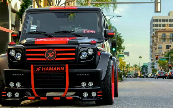 A striking Mercedes-Benz G-Class with a bold black and red design parked on a city street, showcasing its powerful presence and sleek styling in this HD desktop wallpaper.