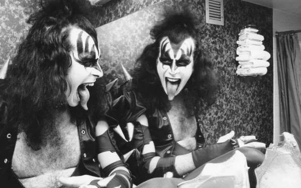 A striking 4K Ultra HD wallpaper featuring a music-themed image of a rock artist in face paint, passionately engaged in a kiss with their own reflection in a mirror.