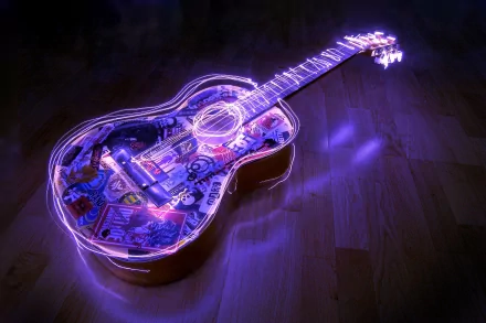 A vibrant guitar illuminated with colorful light effects, resting on a wooden floor, serves as an engaging HD desktop wallpaper and background for music enthusiasts.