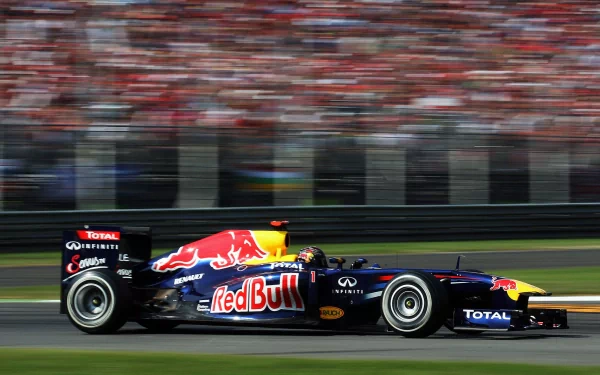F1 sports HD PC desktop wallpaper/background showing a Red Bull Formula 1 car streaking past with motion blur and packed grandstands.