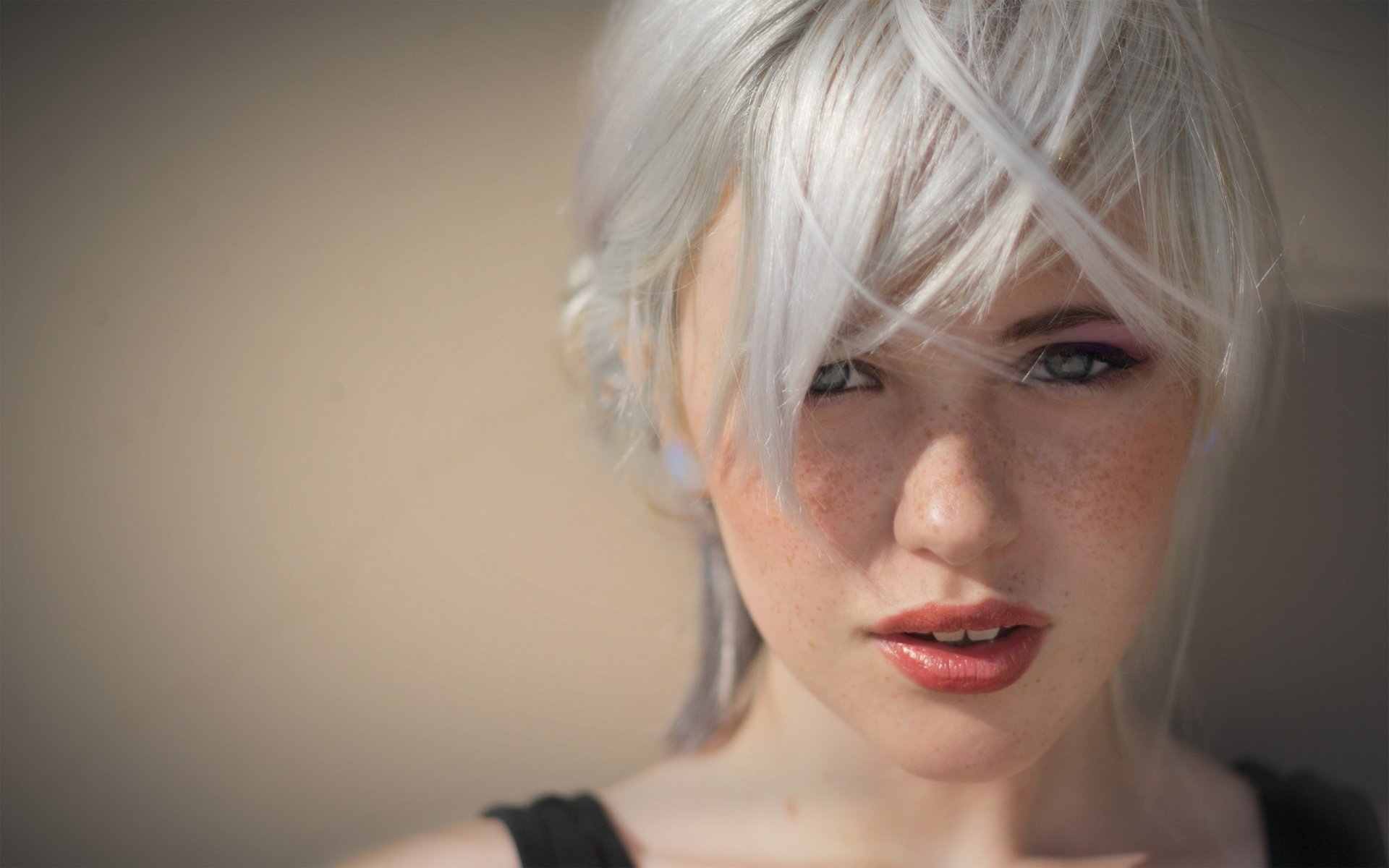 A close-up of a woman with silver hair and soft features, set against a neutral background, making for a striking HD desktop wallpaper and background.