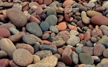 HD PC desktop wallpaper and background: close-up of multicolored smooth river stones filling the frame, nature stone texture and pattern.