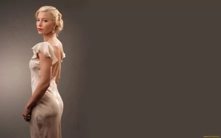 A high-definition wallpaper featuring celebrity Jessica Biel, elegantly posed in a stunning dress against a neutral background, exuding glamour and sophistication.