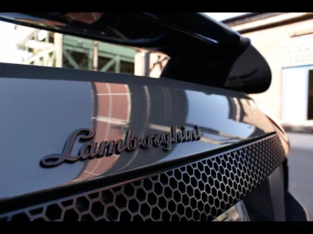 Close-up view of the Lamborghini Murcielago LP badge on the rear grille, featured in an HD PC desktop wallpaper and background.