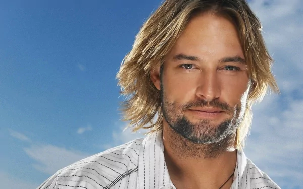 HD PC desktop wallpaper featuring a close-up of celebrity Josh Holloway with a slight smile against a clear blue sky background.