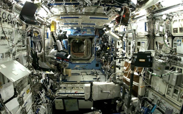 Interior view of the International Space Station, showcasing NASA's intricate man-made environment filled with advanced technology and equipment. HD PC desktop wallpaper and background.