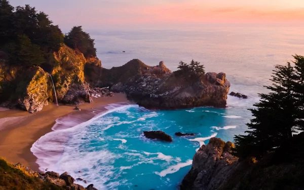 4K Ultra HD desktop wallpaper showcasing a serene coastline with rugged cliffs, turquoise waves, and a pastel sunset sky blending into the tranquil ocean.