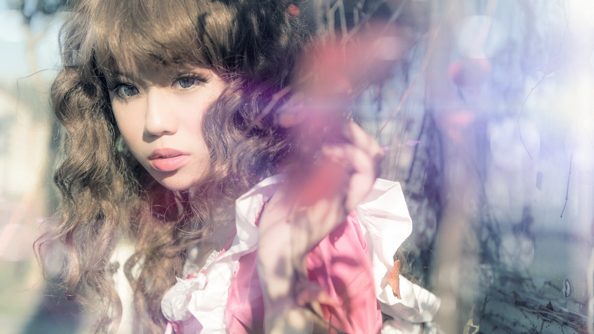 HD desktop wallpaper featuring an Asian woman with wavy hair and soft lighting, creating a dreamy, ethereal atmosphere.