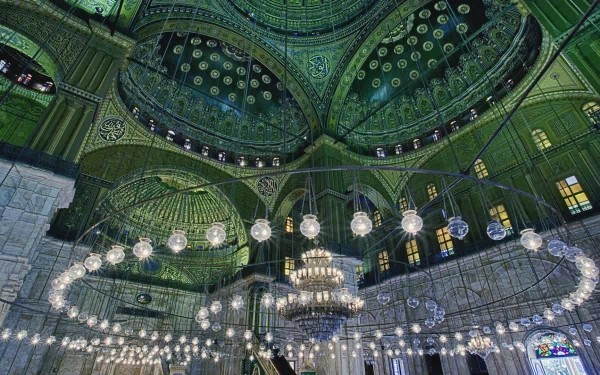 HD desktop wallpaper showcasing the intricate green-tiled interior and ornate chandeliers of the Mosque of Muhammad Ali, highlighting its religious architectural beauty.