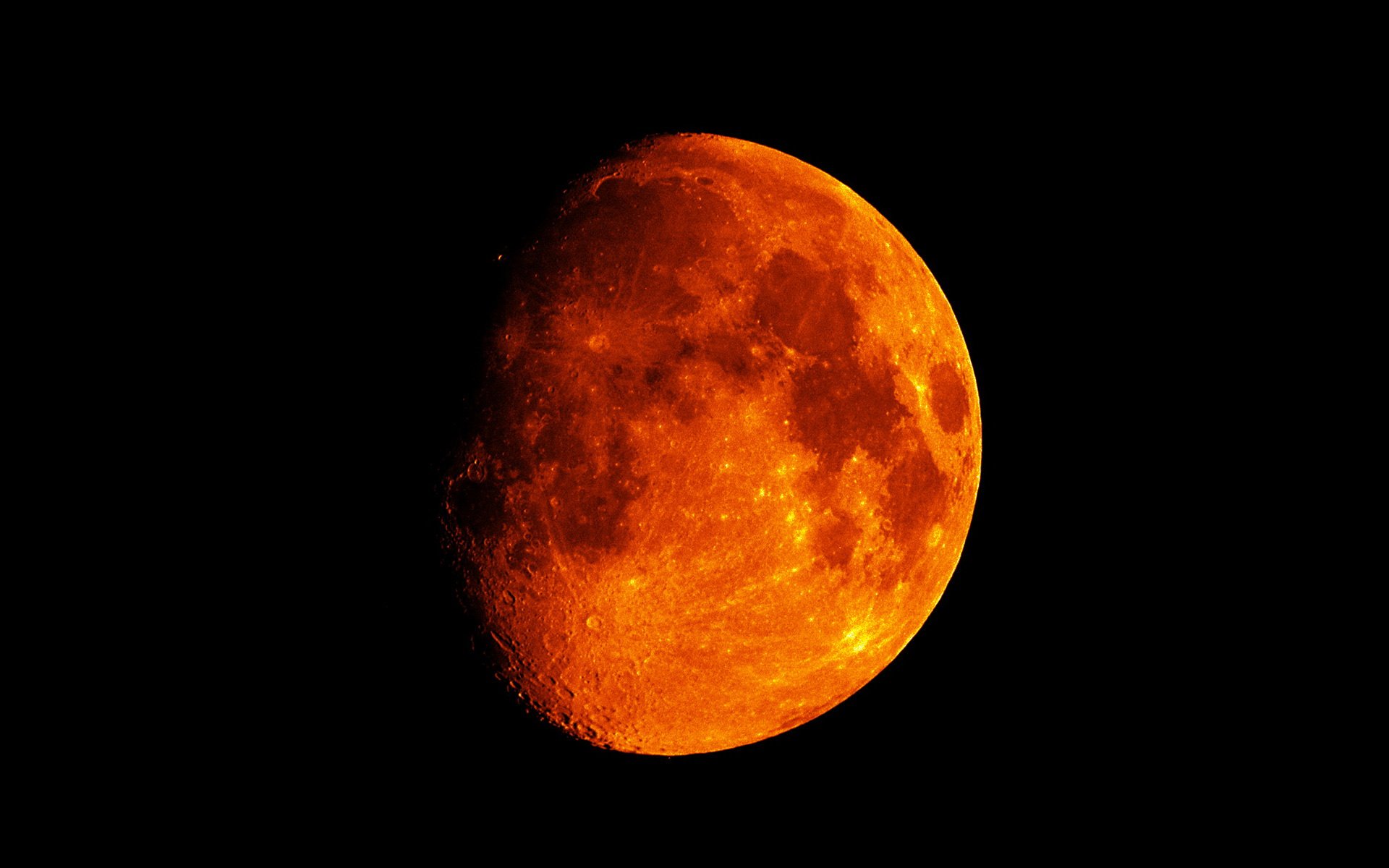 Nature-themed HD PC desktop wallpaper showing a close-up fiery orange moon against a pitch-black sky.