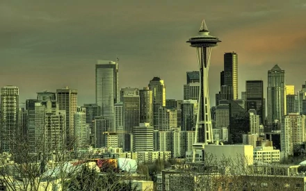 HD desktop wallpaper showcasing the iconic man-made Seattle skyline with the Space Needle prominently featured against an evening sky.